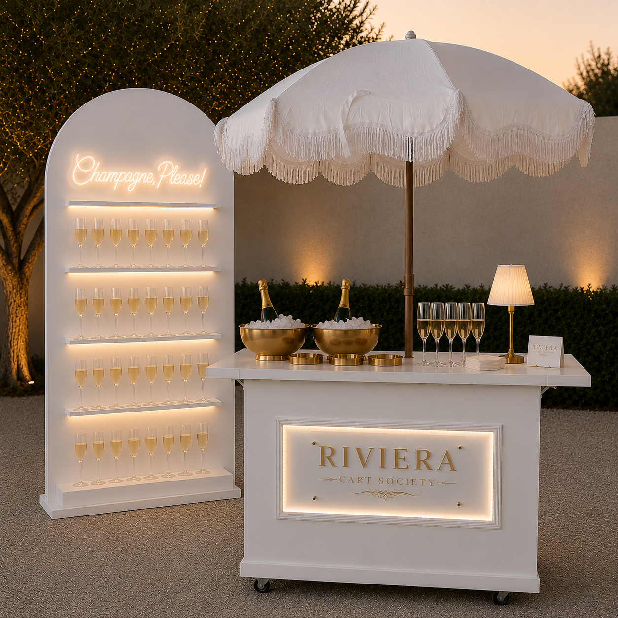 Riviera Cart Society champagne cart and illuminated wall dressed with white florals for a Cannes reception
